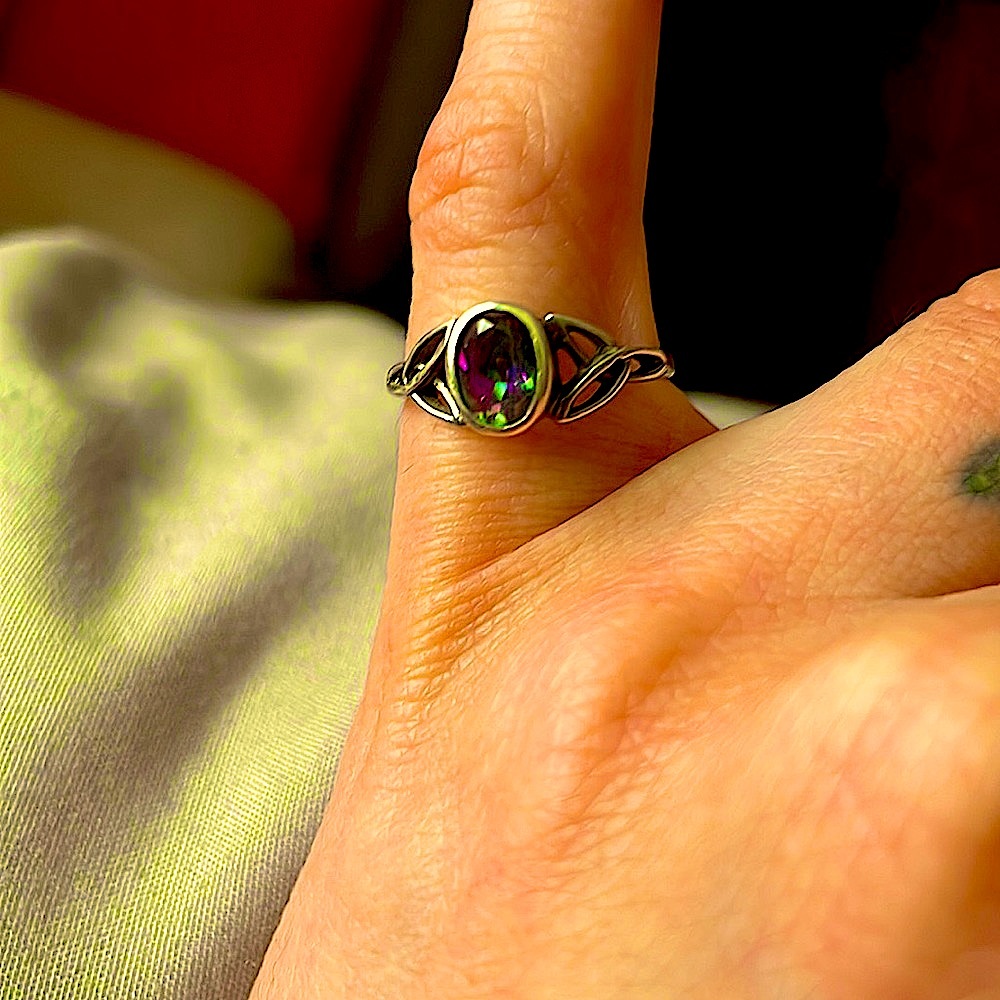 Sterling silver cutout dainty ring with color changing alexandrite gemstone.